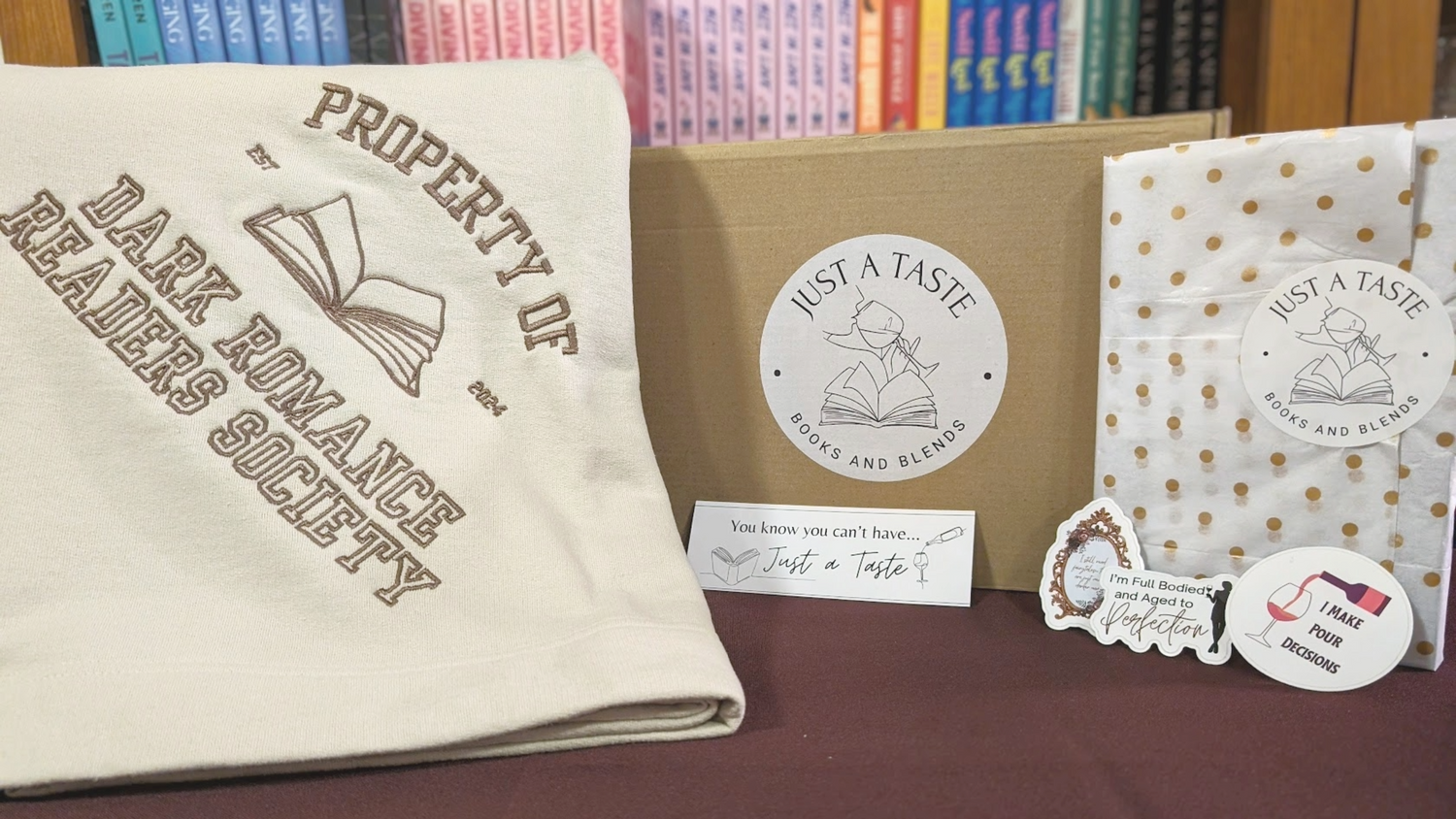Dark Romance Readers Society book with 'Just a Taste' branding on a table